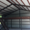 Inside of large metal building with red iron materials - JAG Metals LLC in Weatherford, TX