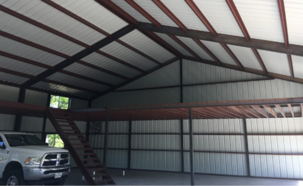 Inside of large metal building with red iron materials - JAG Metals LLC in Weatherford, TX